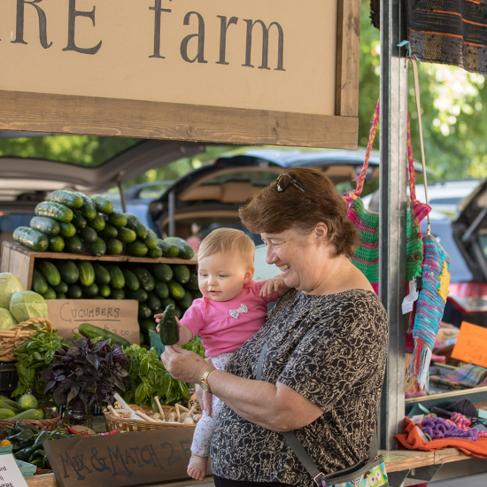 Woman and child shopping for healthy food at farmer's market