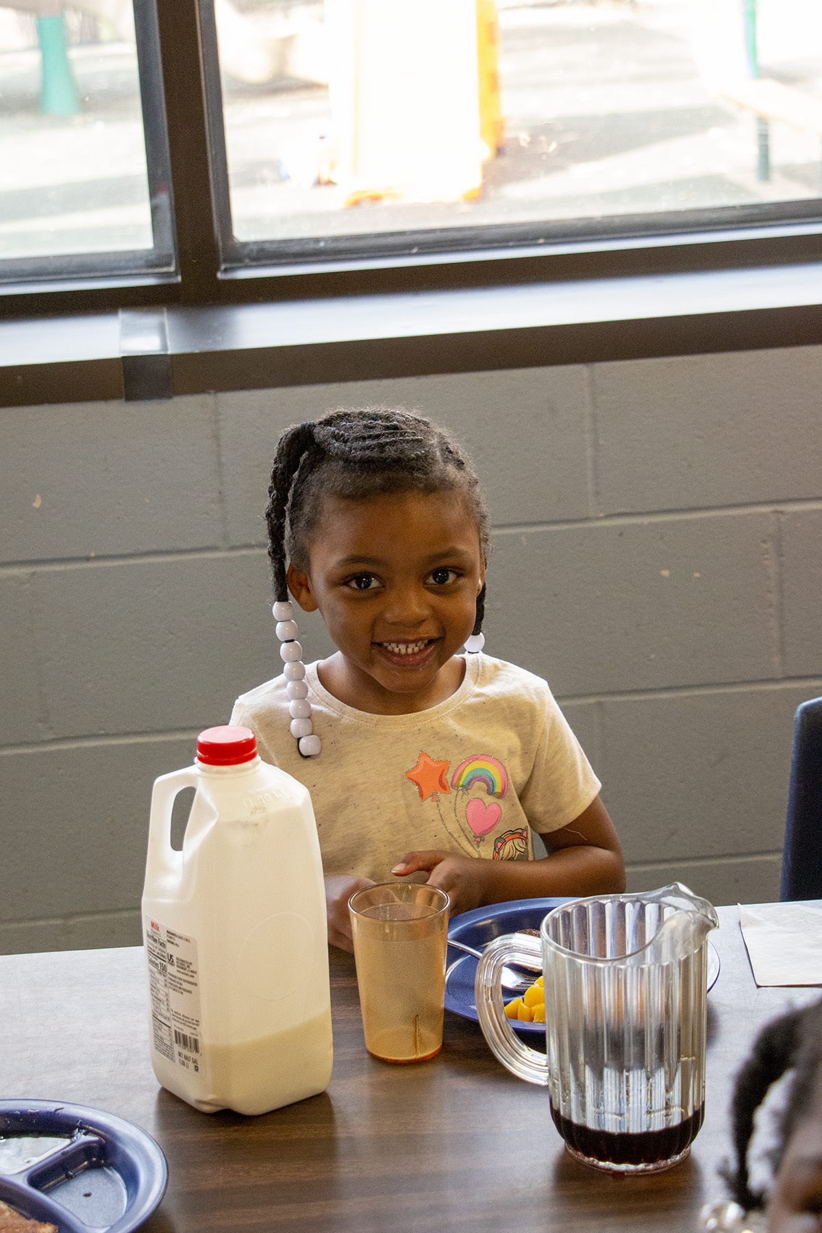 Girl at breakfast at Child Development Center