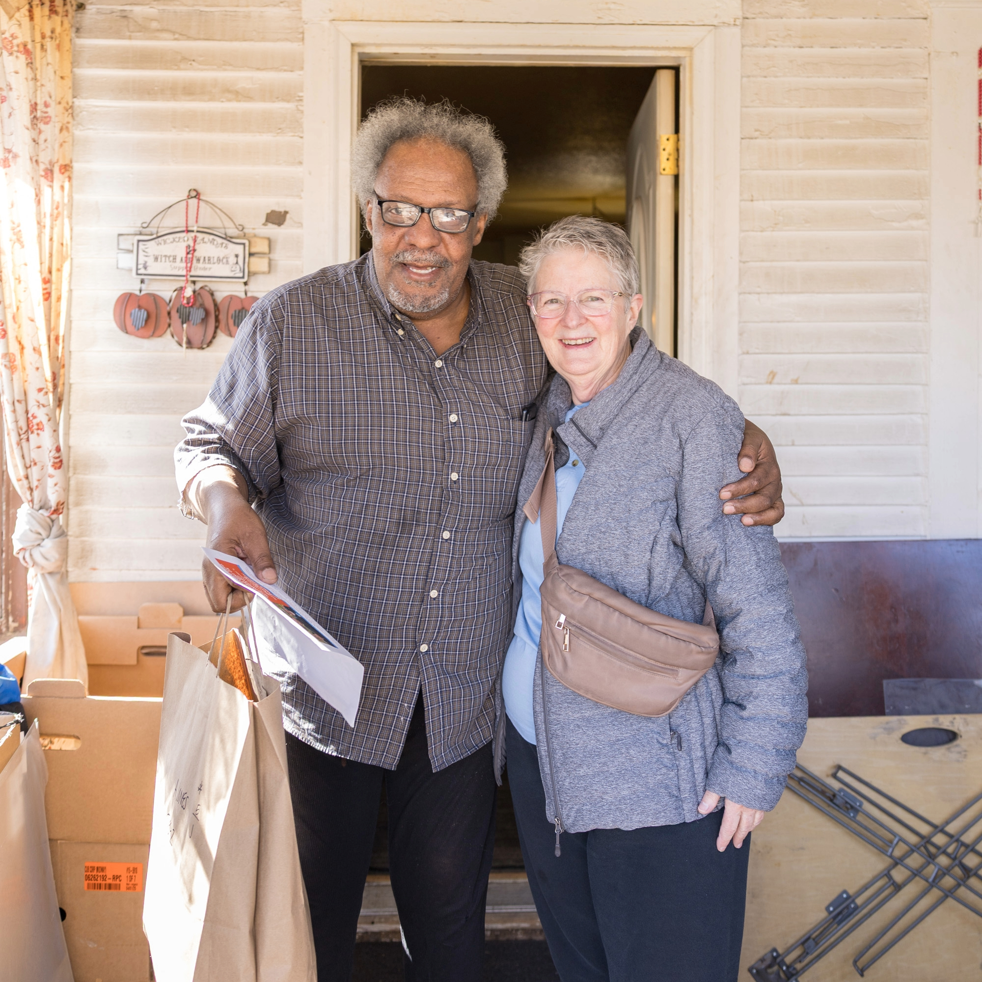 Meals on Wheels volunteer posing with client she delivered to.