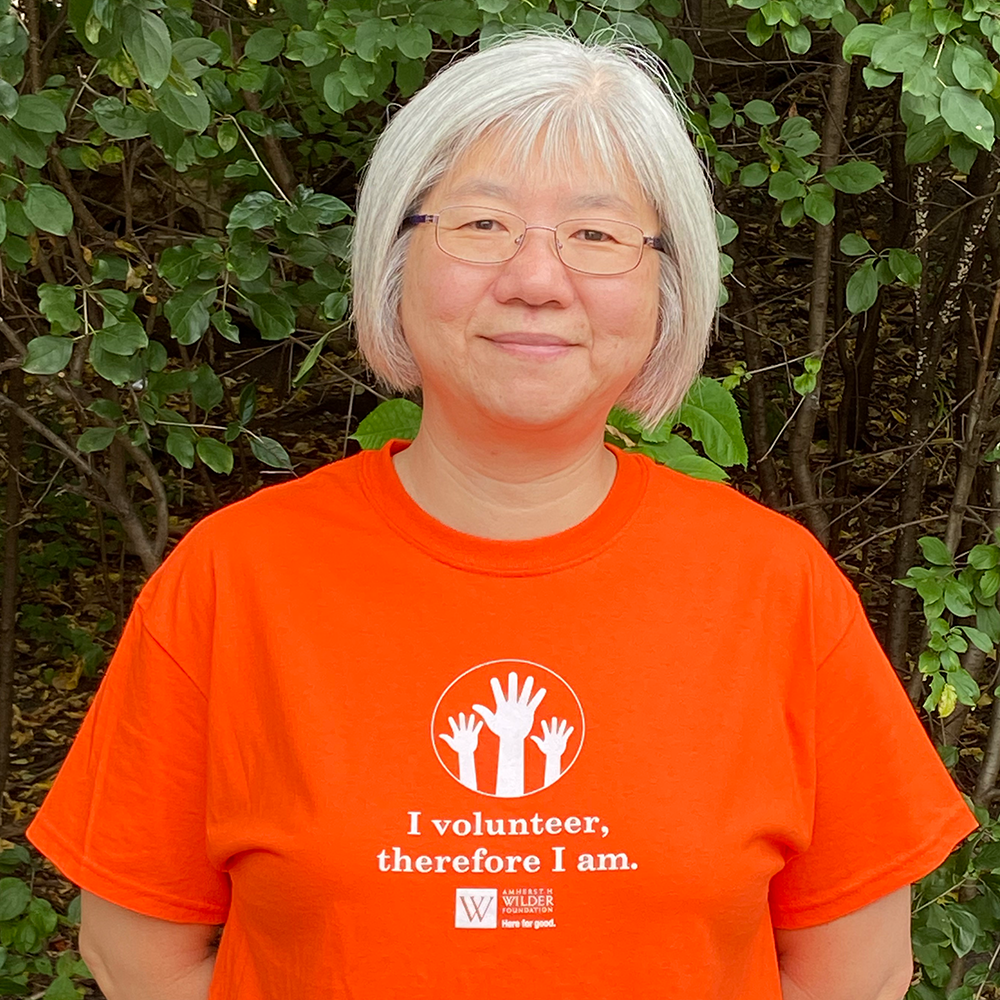 Asian female volunteer in orange t-shirt