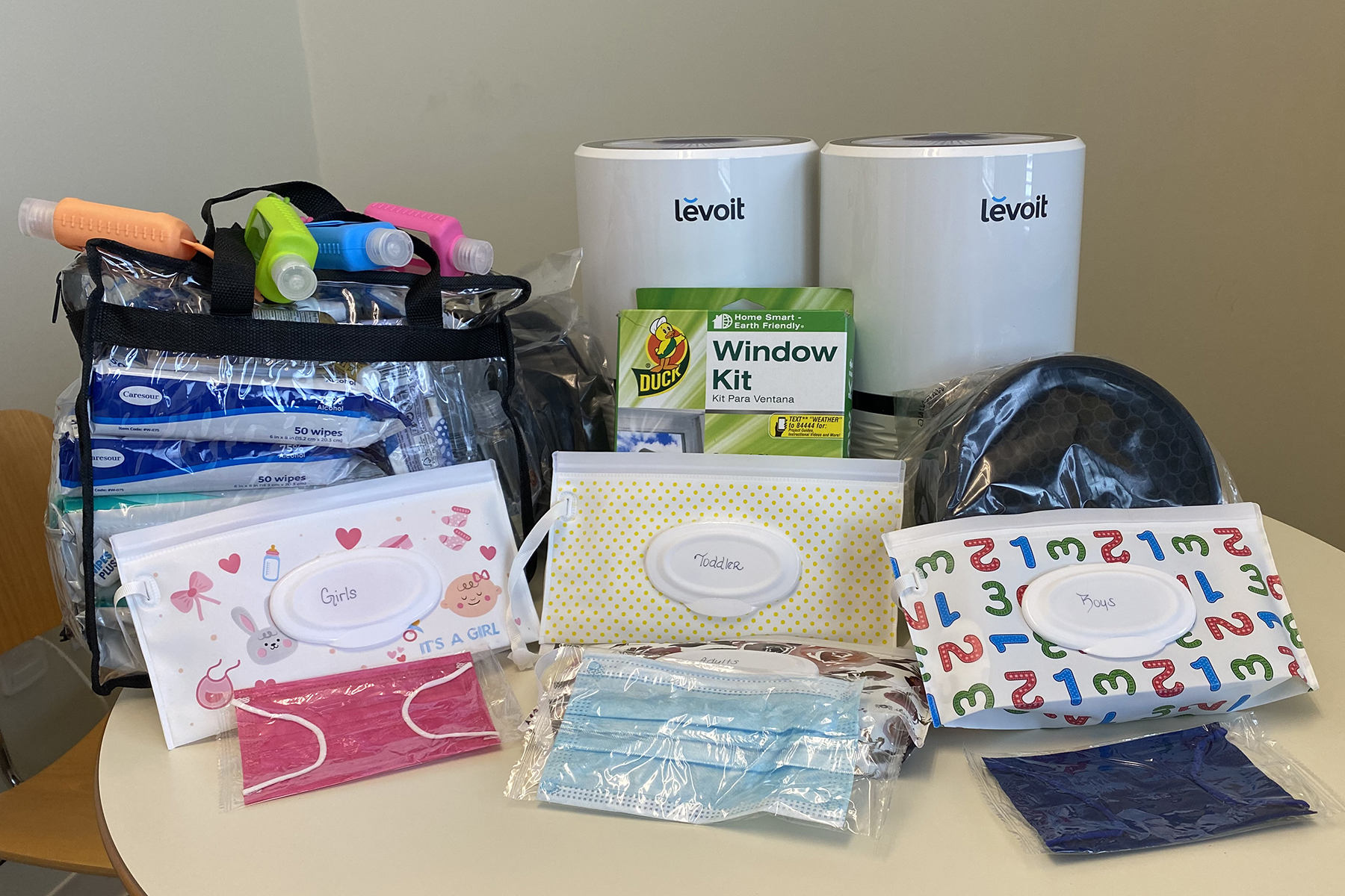 Bottles, packages of wipes, masks, window covering and air purifiers for participants in Homework Starts with Home, a stable housing initiative