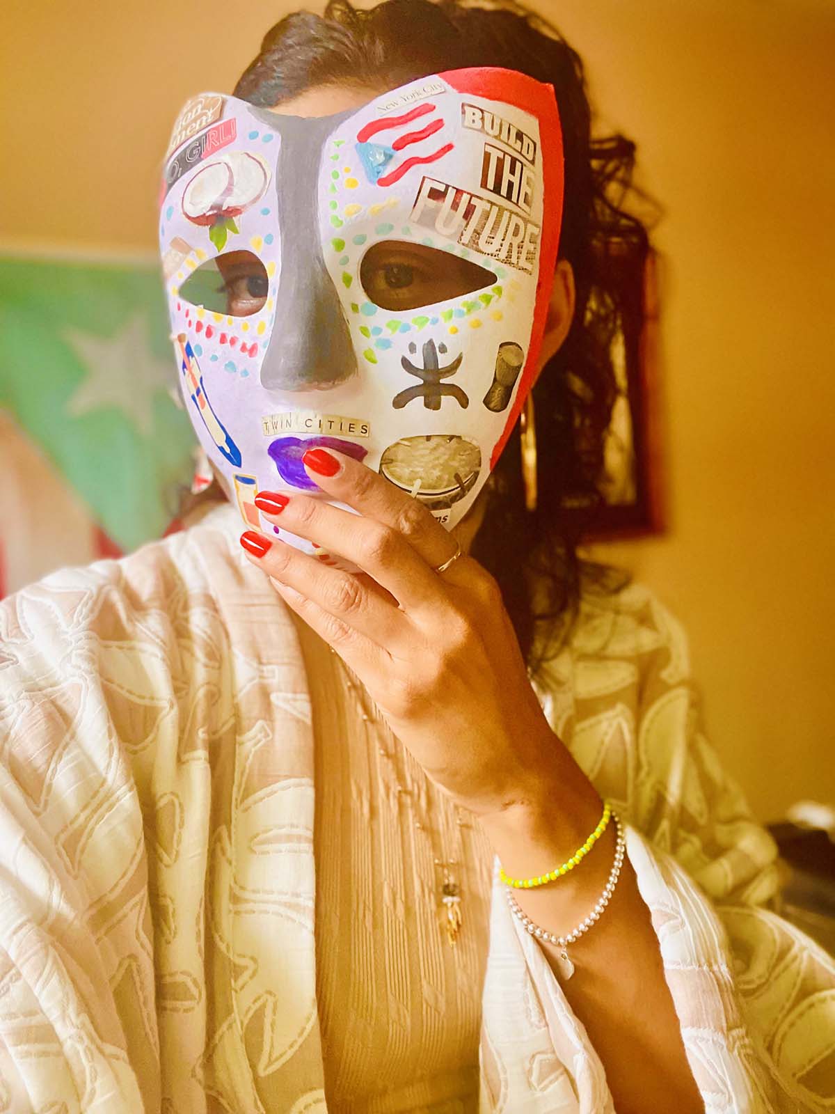 Community Equity Program Maria Isa posing with a handmade paper mache mask over her face