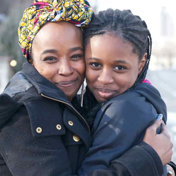 Two African American women embracing each other