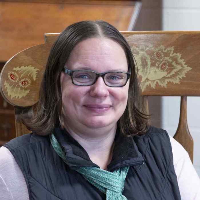 Angela Clair, director of Child Development Center, sitting in rocking chair