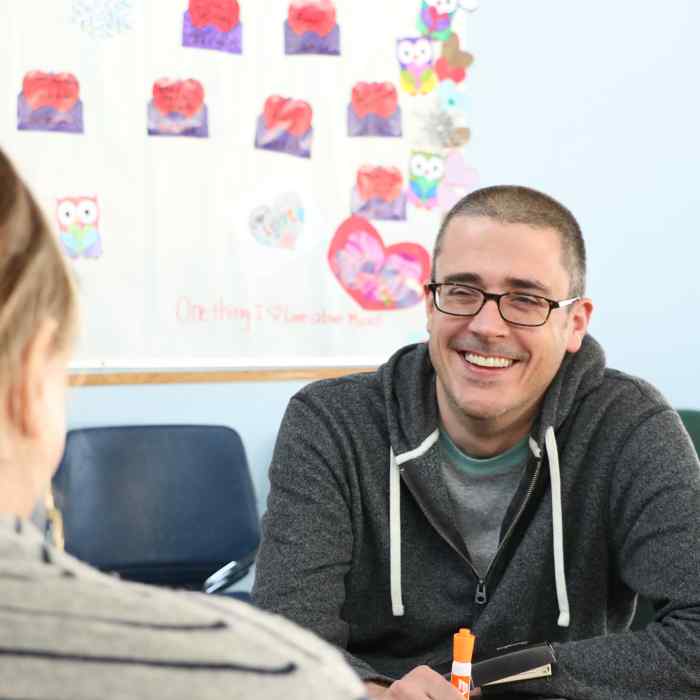 Day Treatment counselor smiling across table