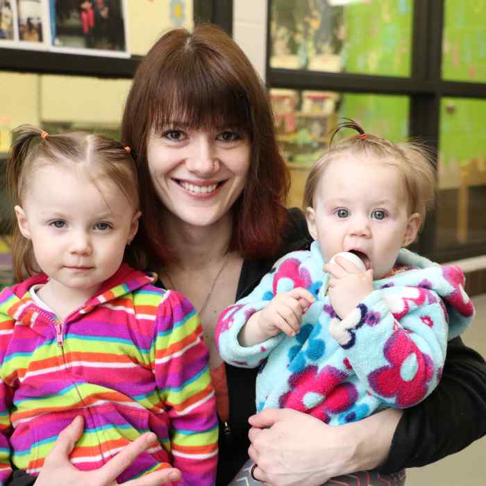 Mother with two daughters in school hallway