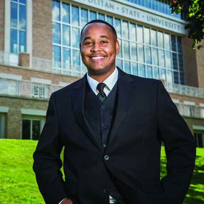 African American man smiling in suit, African and Native American adult, person of color, Kofi alum, Wilder school-based mental health program graduate