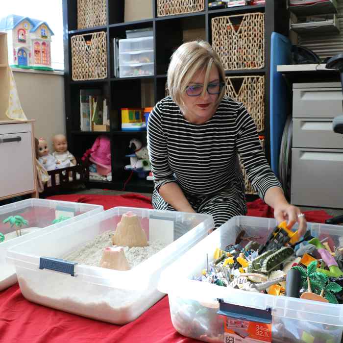 Therapist setting up play therapy toys