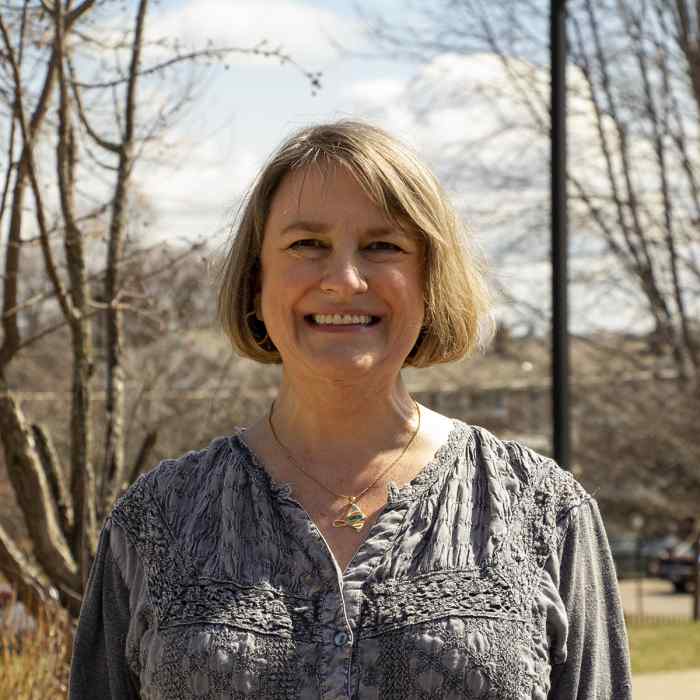 Shari Sibbald, Wider supportive housing employee, smiling with outdoor background