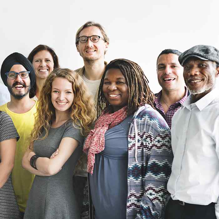 A group of people stand smiling at the camera.