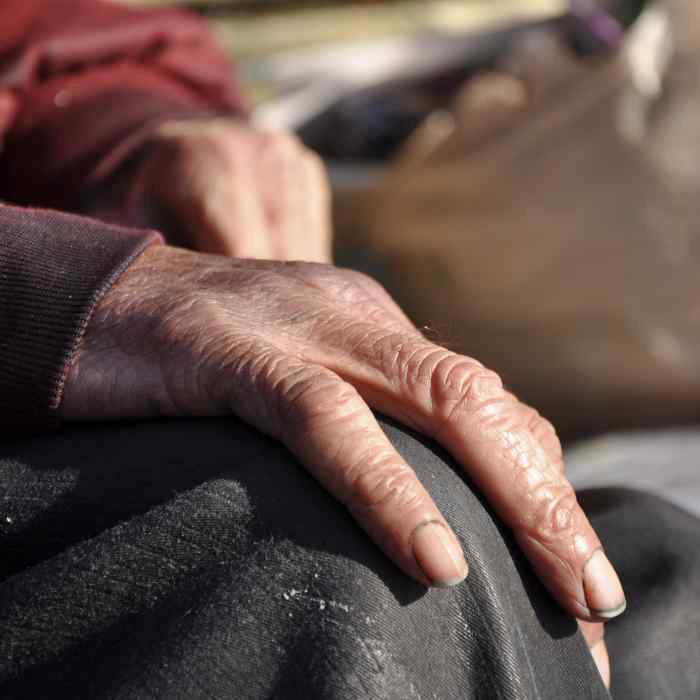 Hand of person resting on their knee