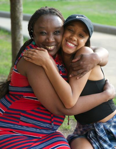 Mother and daughter hugging on a bench