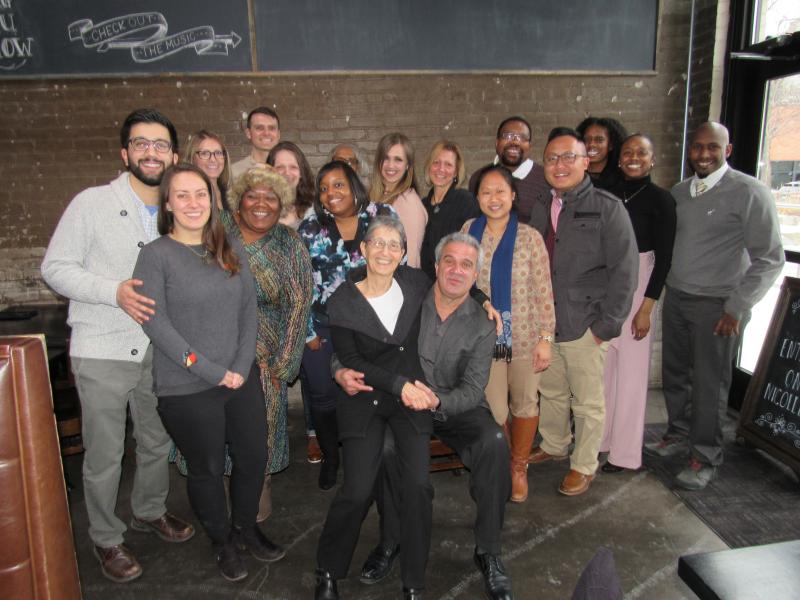 A photo of Rudy Rousseau surrounded by family and colleagues.