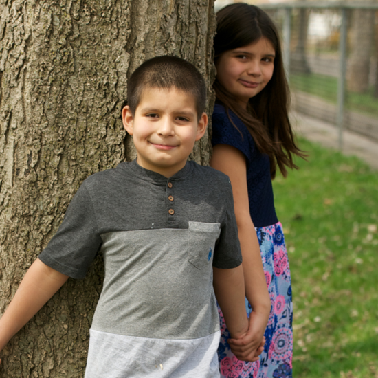 Children playing outside in a yard by a tree Saint Paul, Minnesota