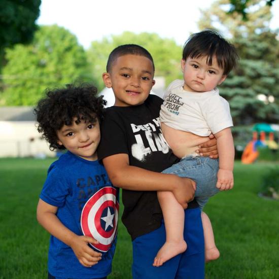 Three small boys pose for the camera