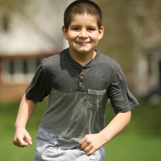A boy runs toward the camera.