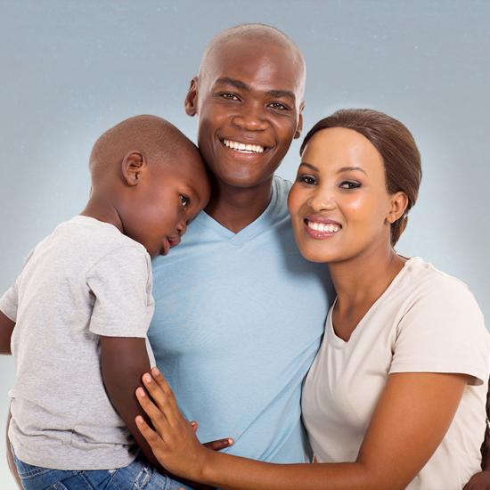 A couple holding a toddler.