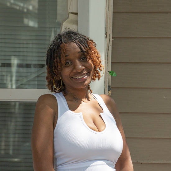 Tonya B. outside the townhouse she found while a participant in Wilder's housing services