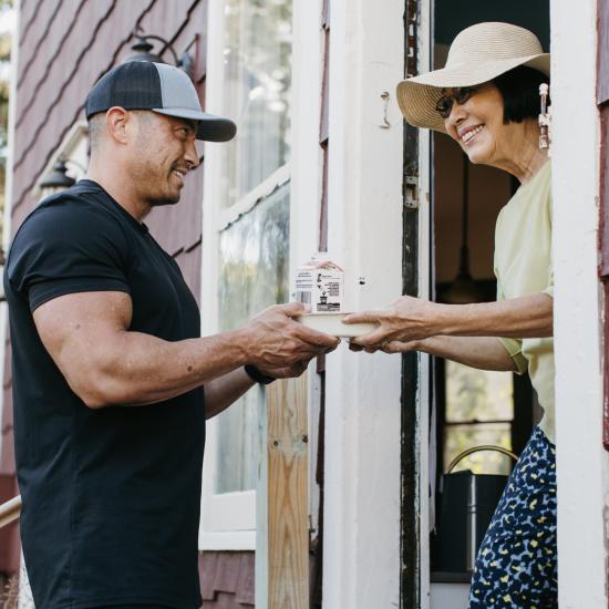 Person delivering Meals on Wheels to a recipient