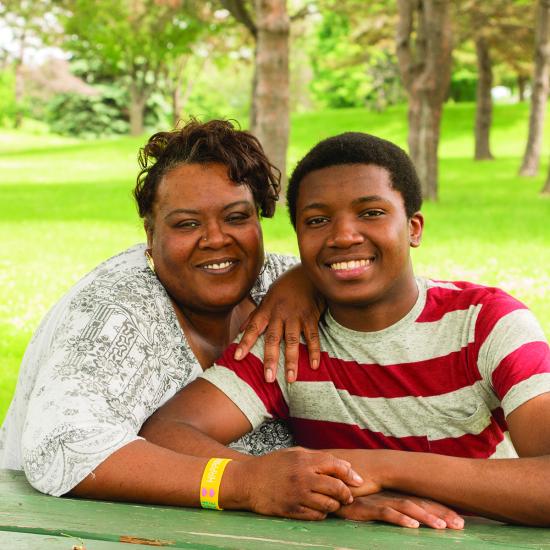 African American mother and son sitting at picnic table, kofi services for african american youth, 