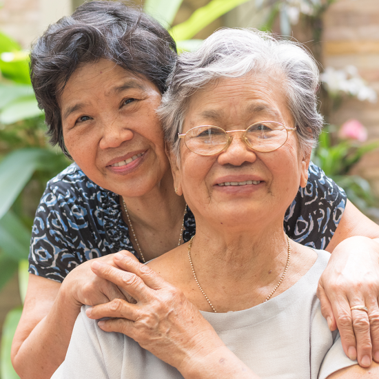 Mom and daughter hugging and smiling