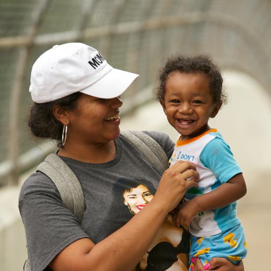 Mom holding laughing baby