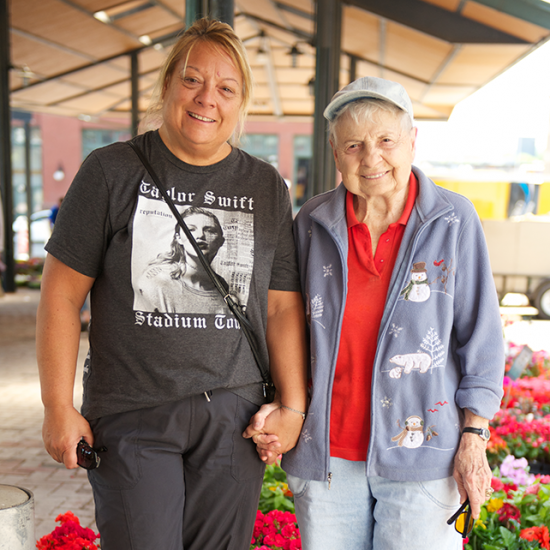 Older adult and their family caregiver at a market in Saint Paul, MN