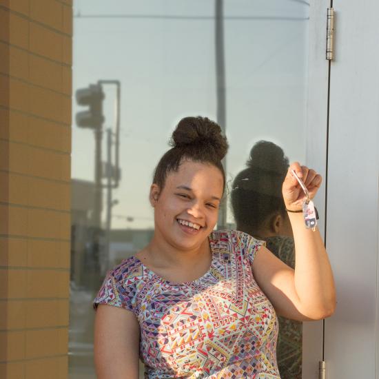 Youth smiling and holding house keys, youth housing site in saint paul, prior crossing resident 