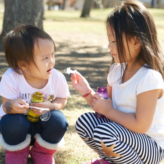 Two young girls playing together.