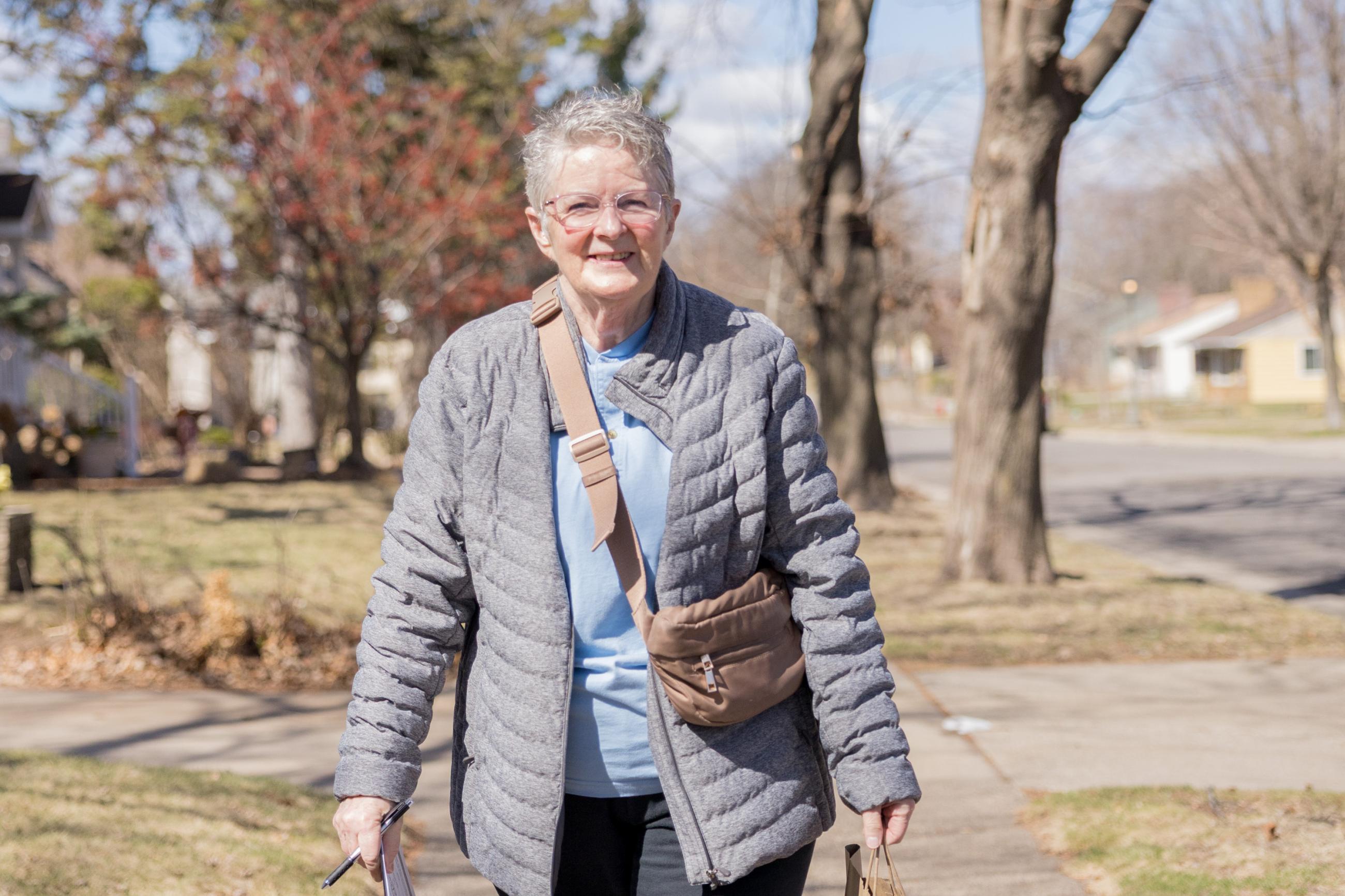 Meals on Wheels volunteer, Anne, walking a Saint Paul neighborhood.