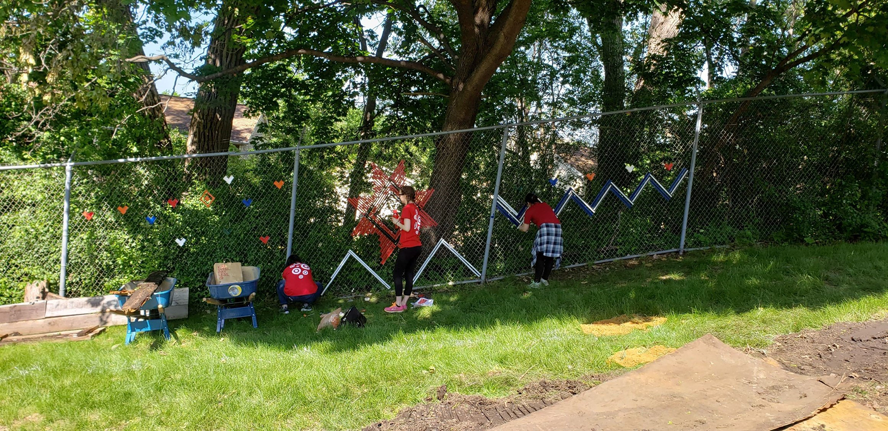 Volunteers working on fence weaving at Wilder Center for Social Healing