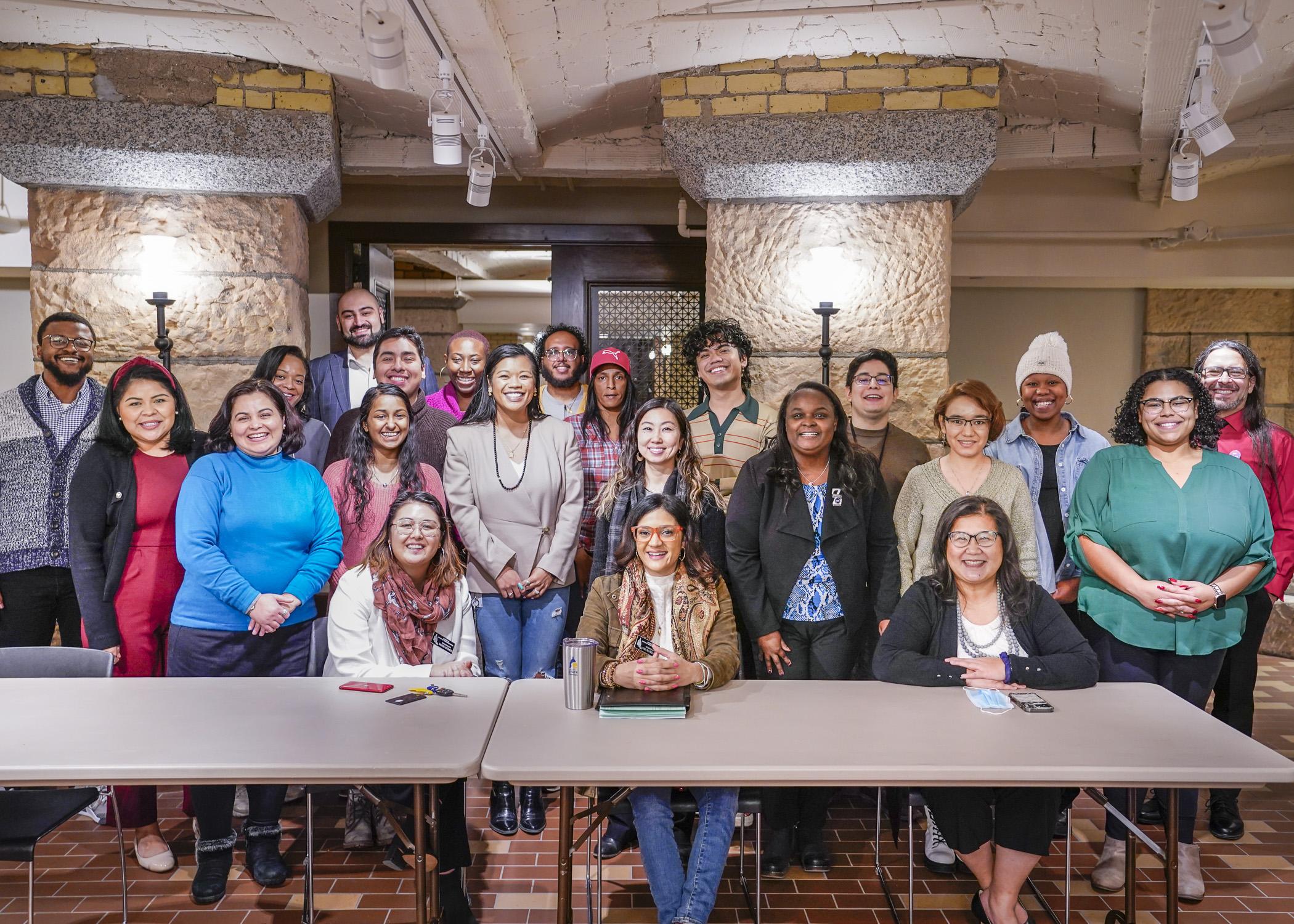 A group of Community Equity Program participants posing with three Minnesota legislators