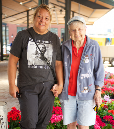 Older adult and their family caregiver at a market in Saint Paul, MN