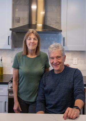 Woman and man stand together in a kitchen