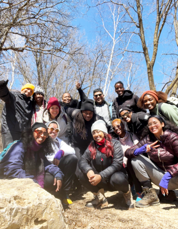 A group of Black, Indigenous and People of Color pausing for a picture while hiking on a retreat with the Community Equity Program at Wilder