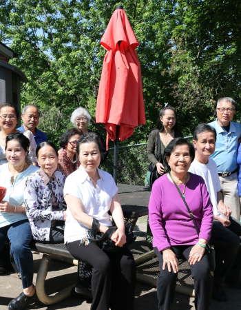Members pose at a table near a donated shed outside the Wilder Center for Social Healing.