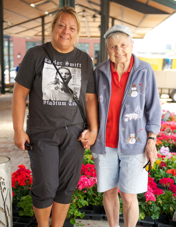 Older adult and their family caregiver at a market in Saint Paul, MN