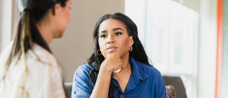 Empathetic therapist listens to female client