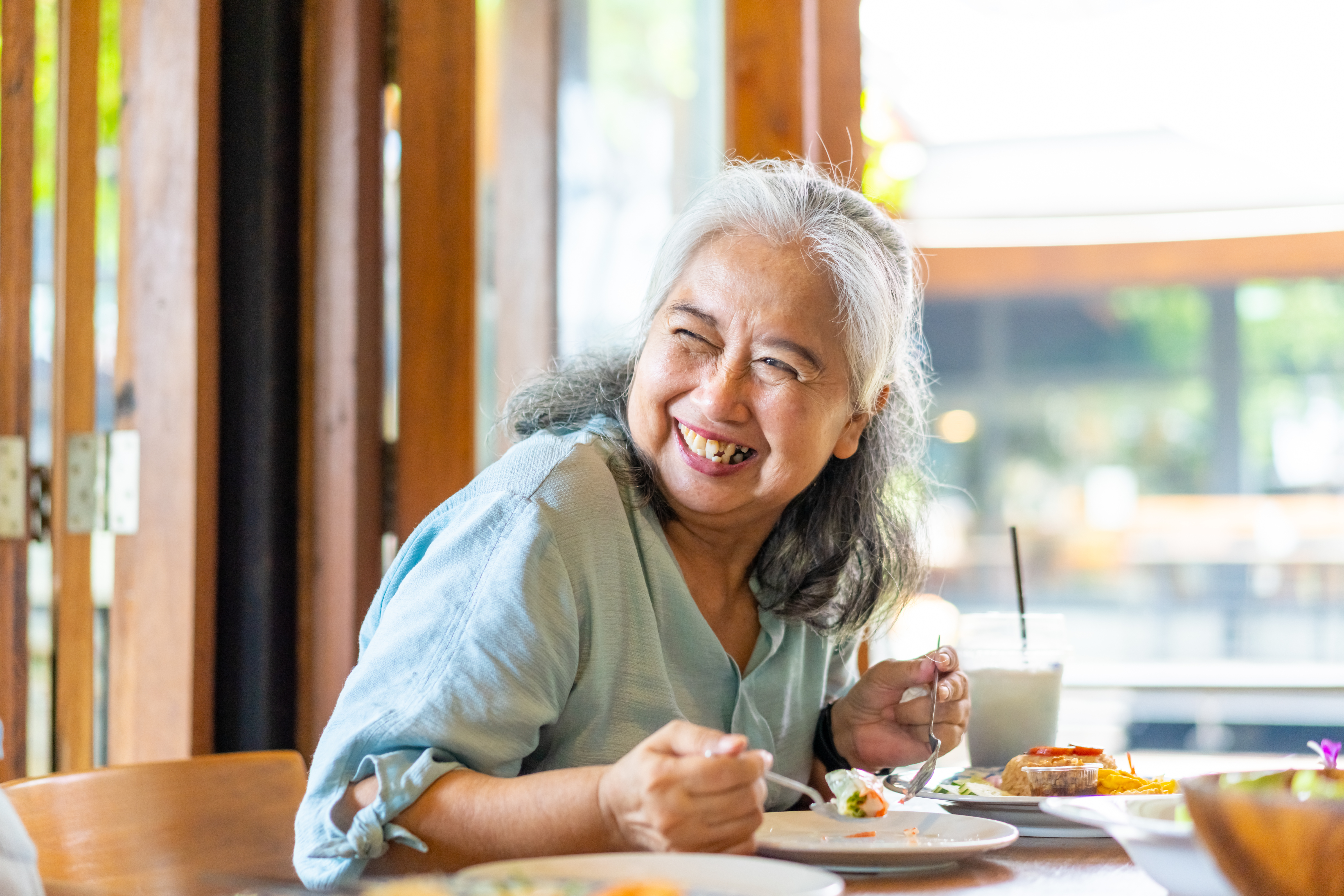 Group of Asian senior women having lunch together at restaurant
