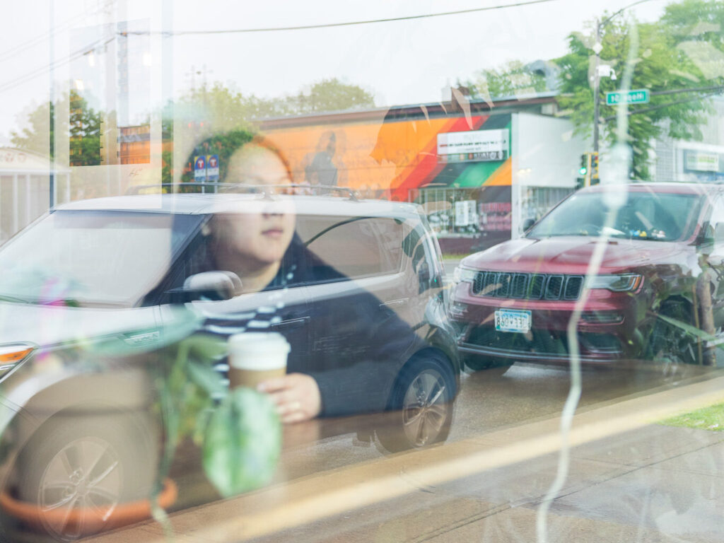 May looks out a window toward the East Saint Paul neighborhood where she grew up.