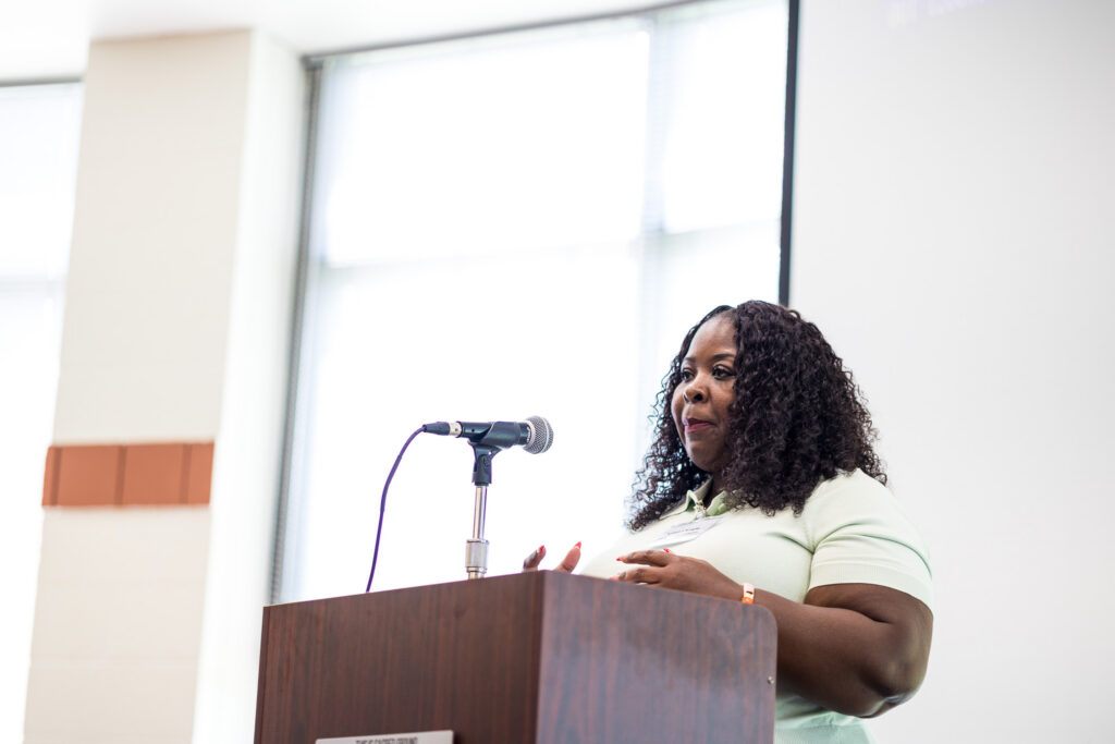 Kimelyn Knight on stage sharing about the realities of the aging population.