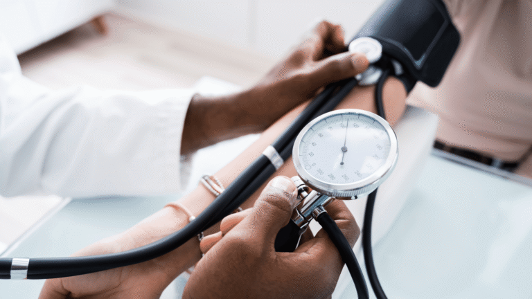 One pair of hands taking a blood pressure on a different person's arm