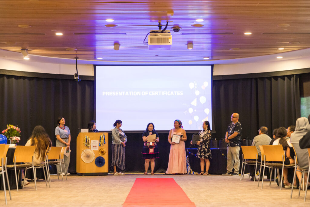 Wilder school-based mental health staff from Hlub Zoo and ThayGeMoo presenting awards to their students.