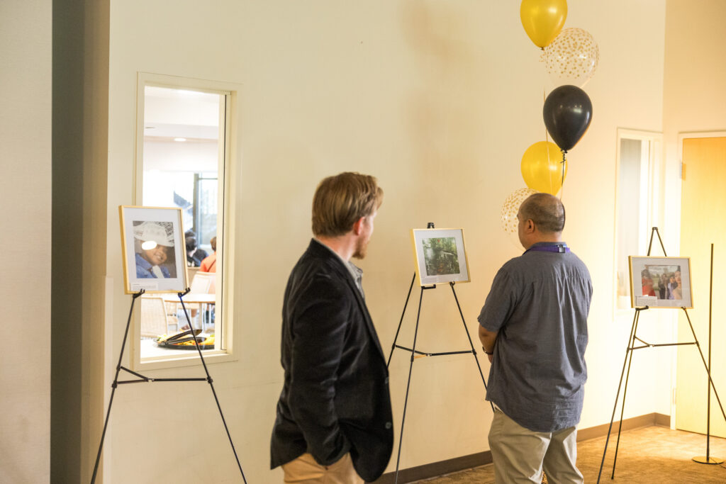 Wilder school-based mental health staff taking a moment to reflect and enjoy the Unity photography exhibit.